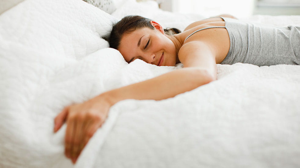 Deals for key workers woman smiling comfy bed